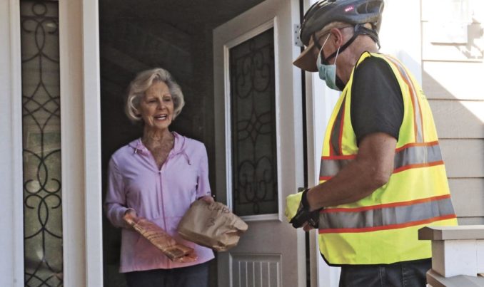 Volunteer delivering a meal to a Meals on Wheels client
